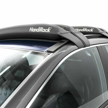 Rear profile view showing the low-profile design and easy strap installation of the HandiRack inflatable bars on a bare roof sedan