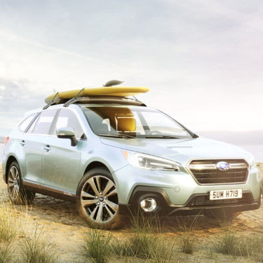 Subaru Outback with two stand up paddleboards loaded on a HandiRack inflatable roof rack system near Jupiter Florida