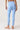 A person shown from the back wearing light blue high-waisted leggings with a small side cutout near the ankle.