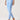 A model wearing light blue high-waisted leggings with a side cutout near the ankle.