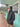 Man wearing ID Simmons black hooded puffy jacket outside surf shop