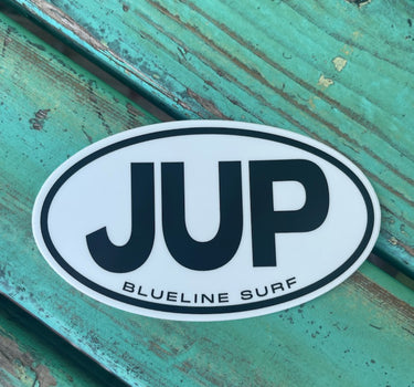 JUP Blueline Surf and Paddle Co. 5-inch sticker featuring bold black JUP logo and Blueline Surf text, on a white oval inside a black circle. The JUP Sticker. 