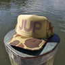 JUP Trucker Hat Tan/Camo with bold JUP lettering and camo brim on dock in Jupiter Florida