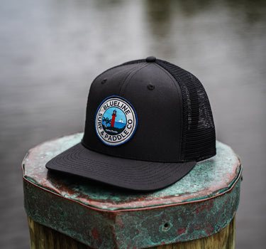 Jupiter Lighthouse Performance Hat in black featuring a premium Jupiter Lighthouse patch and lightweight UV Lite performance construction.