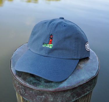 Breaker blue Jupiter Lighthouse Strapback Hat from Blueline Surf & Paddle Co. featuring embroidered lighthouse artwork and relaxed coastal styling inspired by the Jupiter Florida lifestyle.