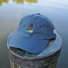Breaker blue Jupiter Lighthouse Strapback Hat from Blueline Surf & Paddle Co. featuring embroidered lighthouse artwork and relaxed coastal styling inspired by the Jupiter Florida lifestyle.