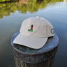 Putty colored Jupiter Lighthouse Strapback Hat from Blueline Surf & Paddle Co. featuring embroidered lighthouse artwork and relaxed coastal styling inspired by the Jupiter Florida lifestyle.