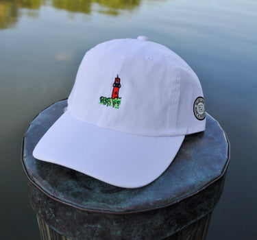 White Jupiter Lighthouse Strapback Hat from Blueline Surf & Paddle Co. featuring embroidered lighthouse artwork and relaxed coastal styling inspired by the Jupiter Florida lifestyle.