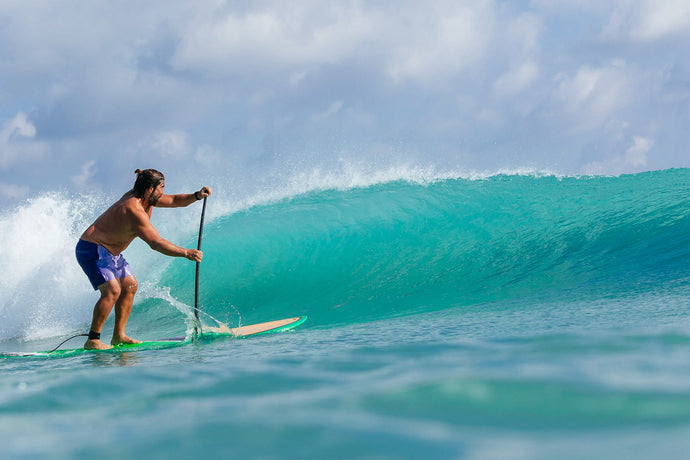 Paddle surfer trimming down the line of a clean teal wave in Jupiter, Florida. Photo: Greg Panas