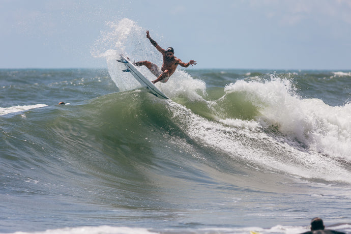 Surfer in the air with fins showing in Jupiter, Florida. Photo: Greg Panas