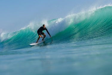 Longboarder setting up in a clean teal barrel in Jupiter, Florida. Photo: Greg Panas