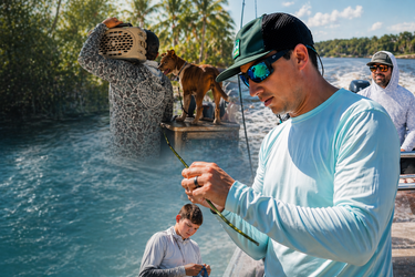 Men wearing lightweight UV sun shirts fishing on a boat in Jupiter, Florida, showcasing breathable performance apparel for boating and coastal lifestyle.