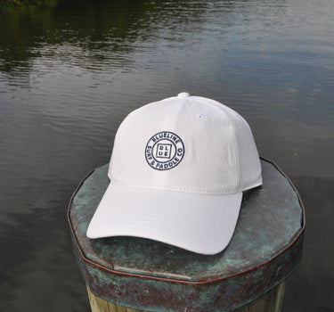 OG Blueline Logo Cotton Twill White Hat displayed on dock by the water