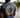 Back view of a navy heather Blueline OG logo T-shirt with large coral circle logo, photographed outdoors in Jupiter, Florida.