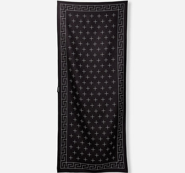 Black scarf with white geometric pattern on a light gray background
