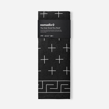 Packaged towel with geometric pattern and 'nomadix' branding on a white background
