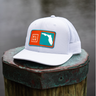 White cap with a colorful logo on a wooden post