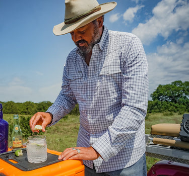 Man wearing a Poncho Blackfin plaid button-down shirt outdoors