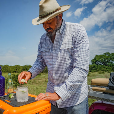 Man wearing a Poncho Blackfin plaid button-down shirt outdoors