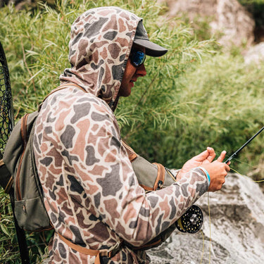 Poncho Shell Bag Duck Camo sun hoodie worn outdoors