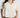 Woman wearing a beige and white patterned shirt against a white background