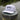 Blueline Rod & Reel Trucker Hat in white and black with vintage fishing patch and breathable mesh back.