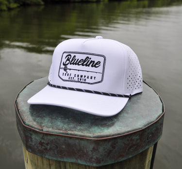 Blueline Rod & Reel Trucker Hat in white and black with vintage fishing patch and breathable mesh back.