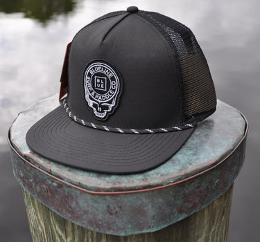 Black Skully rope trucker hat from Blueline Surf & Paddle Co. featuring custom skull artwork and lightweight coastal styling inspired by the Jupiter Florida saltwater lifestyle.