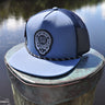 Slate gray and navy Skully rope trucker hat from Blueline Surf & Paddle Co. featuring custom skull artwork and coastal styling inspired by the Jupiter Florida saltwater lifestyle.