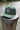 Forest green Skully UV Lite performance rope hat from Blueline Surf & Paddle Co. featuring custom skull artwork and lightweight breathable design inspired by the Jupiter Florida coastal lifestyle.