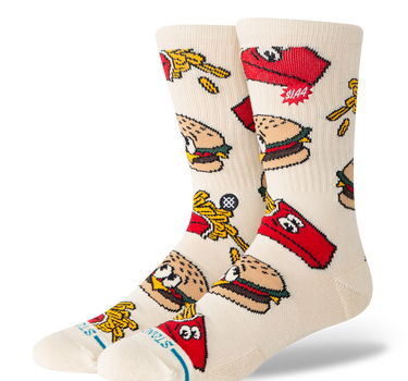 A pair of crew socks in a warm off-white/cream color, featuring a colorful cartoon pattern of burgers & french fries.