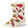 A pair of crew socks in a warm off-white/cream color, featuring a colorful cartoon pattern of burgers & french fries.