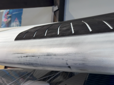 Close-up of the professionally repaired shipping damage on the Starboard Spice Xtec paddleboard.