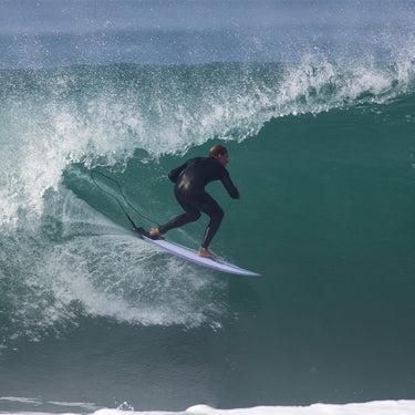Surfer riding Surftech Aipa Dark Twinn shortboard on a clean wave